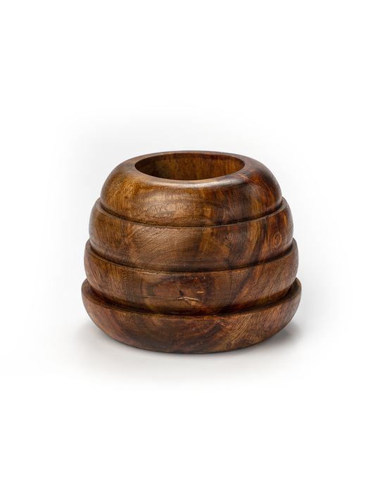 A beehive-shaped planter made of natural wood with visible grain patterns, stacked rings, and a circular opening at the top for planting.