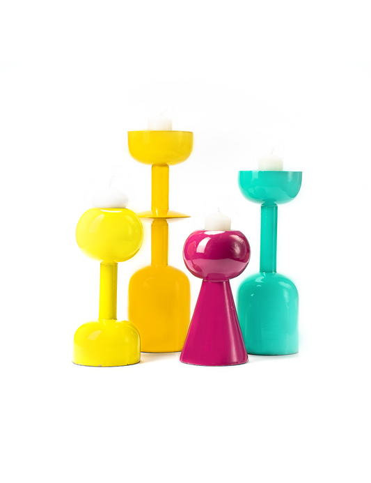 A vibrant colors candle stands with a candle on top, isolated on a white background.