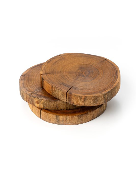 A set of brown wooden coasters with visible wood grain patterns, stacked together.