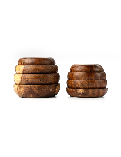 A beehive-shaped planter made of natural wood with visible grain patterns, stacked rings, and a circular opening at the top for planting.