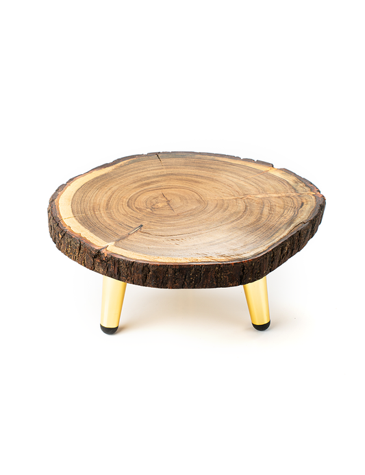 A Coffee Cake Stand with a circular Srich wood top and stainless steel legs, with a gold-colored tip on each leg.