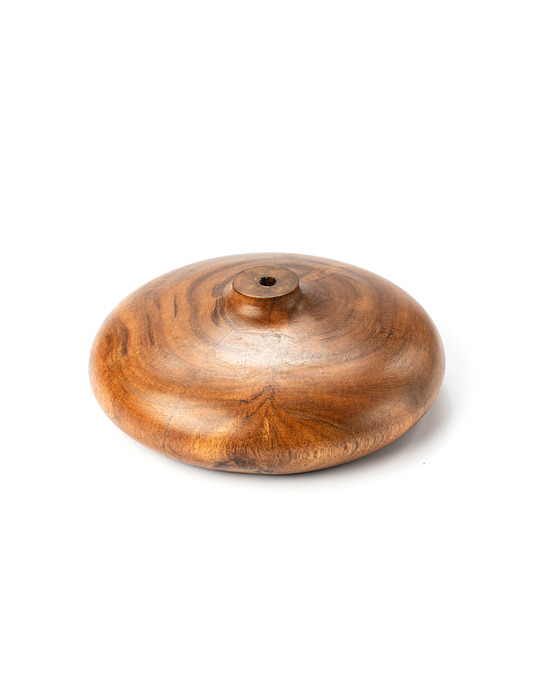 A handcrafted brown wooden vase with a rounded top and a visible wood grain texture.